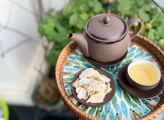 Savoring candied ginger with a cup of hot tea is a simple pleasure. Photo: Minh Anh